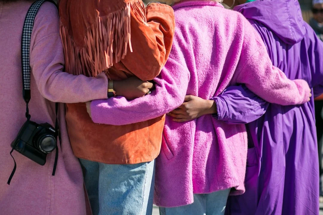 Group of people with their arms around each other