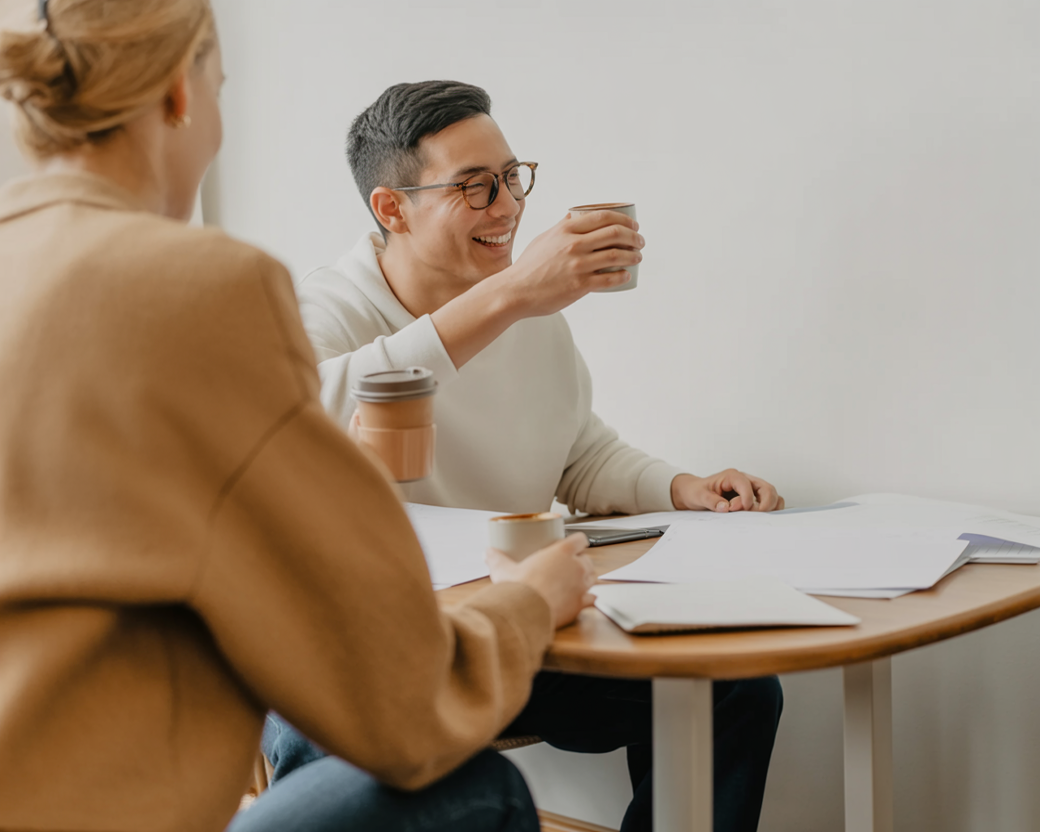 Colleagues talking over coffee at a table