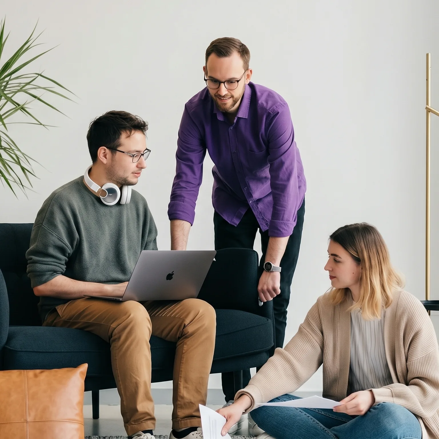 Colleagues gathered around a laptop